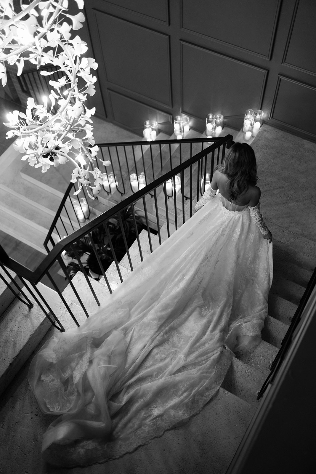 bride with long train trailing down stairs at Switch House