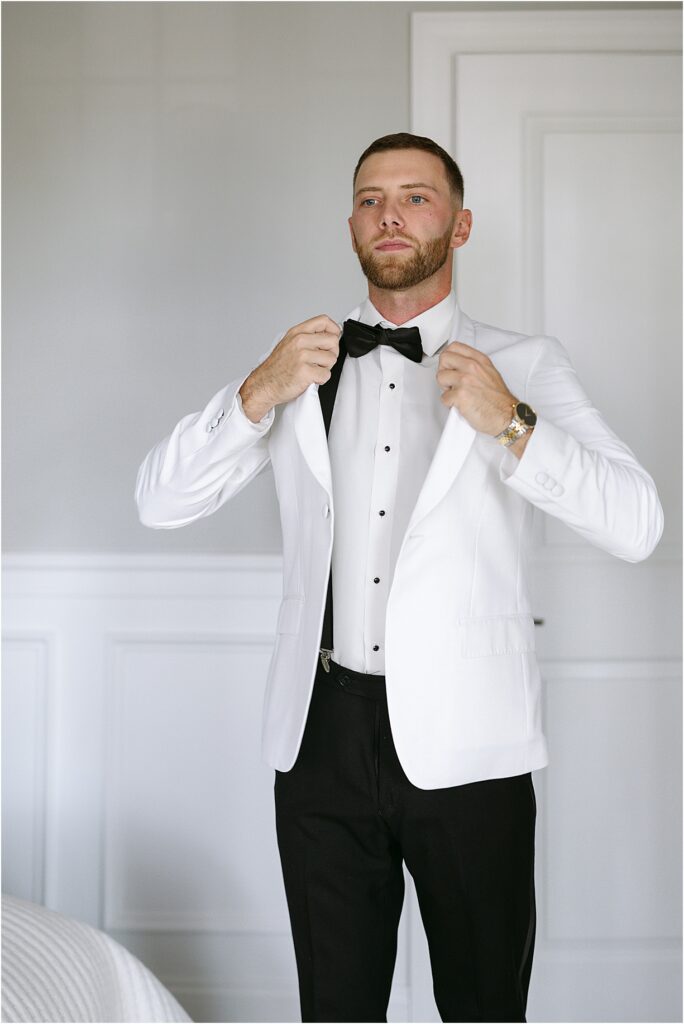 groom putting on jacket