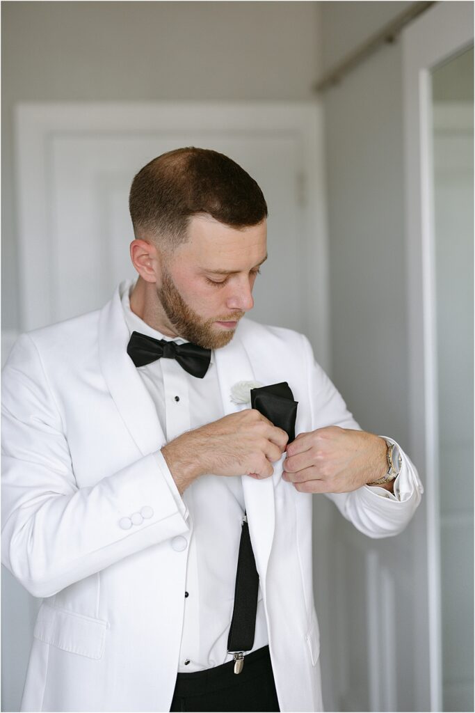 groom putting in his pocket square