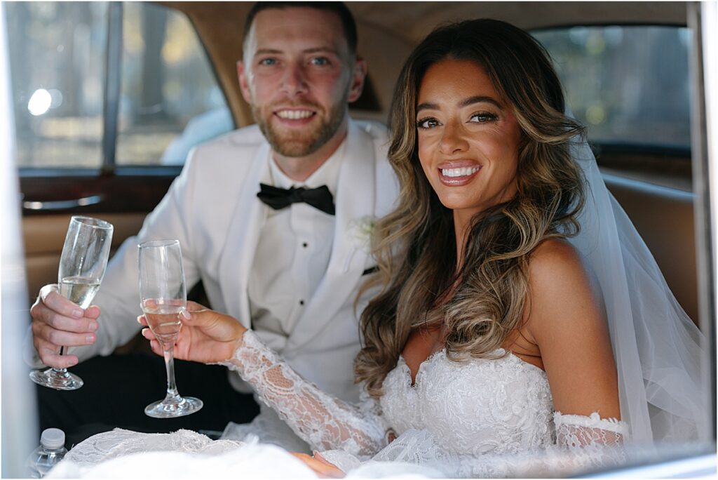 Bride and Groom with champagne in car at Philadelphia editorial wedding at Switch House