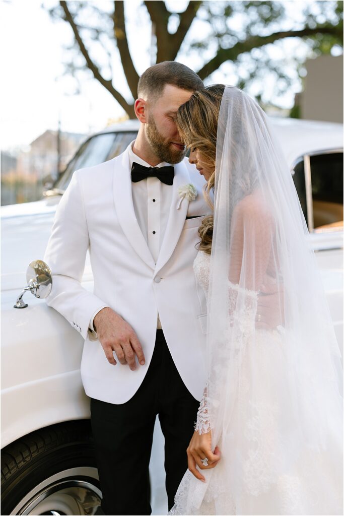 couple posing with car by Philadelphia editorial wedding photographer Kristy Hoadley